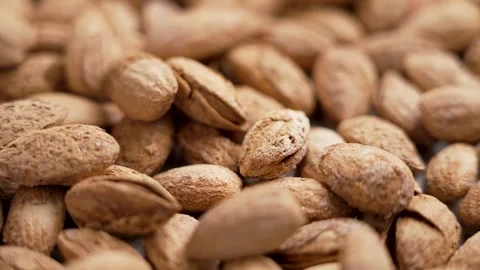 Delicious roasted almond nuts with nutshell falling in slow motion Stock Footage 256708959