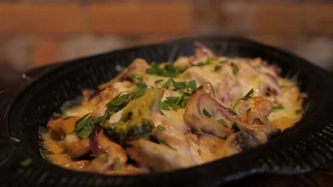 Delicious roasted fish with vegetables and mushrooms under creamy sauce rotates. Video stock 133000699
