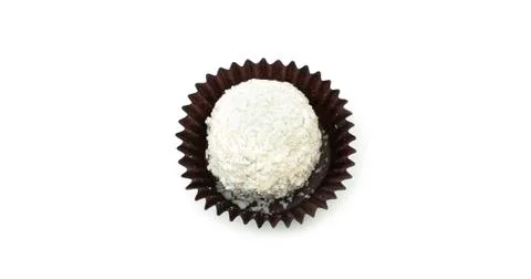 Delicious, round, chocolate candy in wrapper with nuts on a white background. Stock Photos
