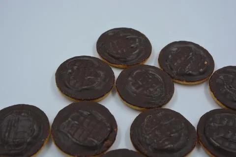 Delicious round sponge cake biscuits with natural are covered with chocolate. Stock Photos