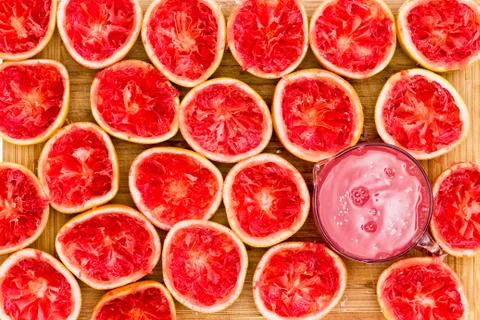 Delicious ruby red grapefruit halves by glass Stock Photos