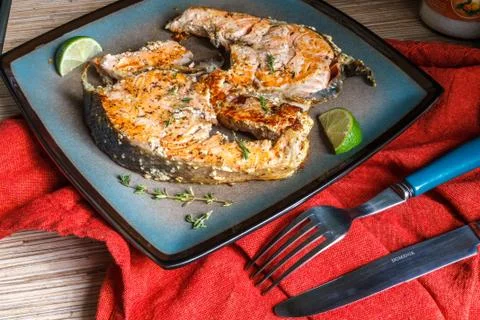 Delicious salmon steak grilled with lemon and pepper on a plate Stock-Fotos