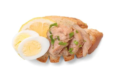 Delicious sandwich with cod liver, lemon and quail egg on white background Stock Photos