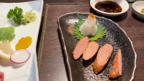 Delicious sashimi and cooked roe presented artfully on a wooden table at a .. Vídeos de archivo 332646351