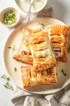 Delicious sausage in puff pastry with thyme and sesame seeds Stock Photos