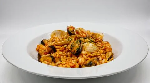 Delicious seafood risotto, Risotto ai frutti di mare, on white dish. Stock-Fotos
