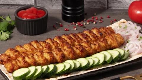 Delicious skewers of fried meat served on a plate with cucumbers Vídeos de archivo 316808853
