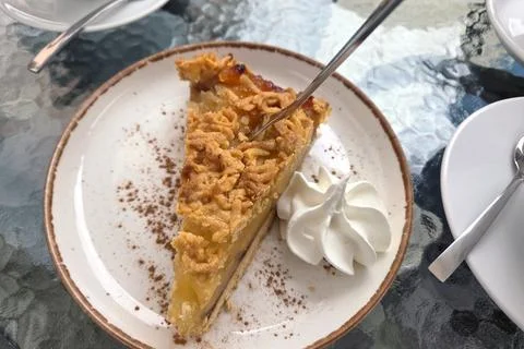 Delicious Slice of Apple Pie with Whipped Cream on a Rustic Plate Stock Photos