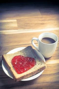 Delicious slice of bread with strawberry jam heart shape 스톡 사진