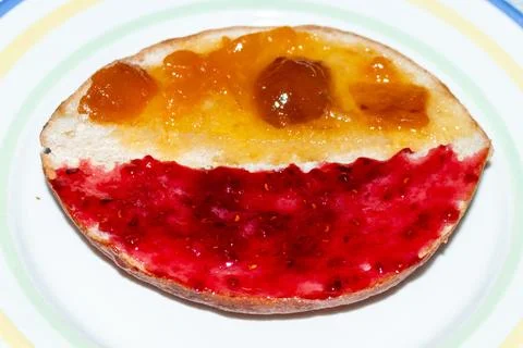 A delicious slice of bread with two types of sweet jam on a plate for breakfast Stock Photos