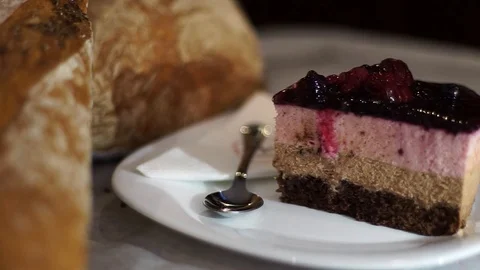 Delicious slice of cake panning into fresh bread loaves Stock Footage 90122457