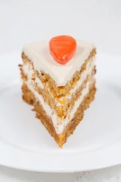 Delicious slice of carrot sponge cake with cream and walnut Stock Photos