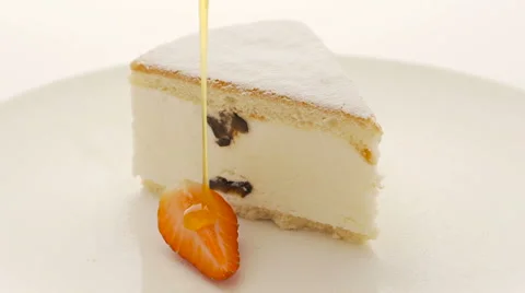A delicious slice of cheesecake with pouring topping. Stock Footage 60712009