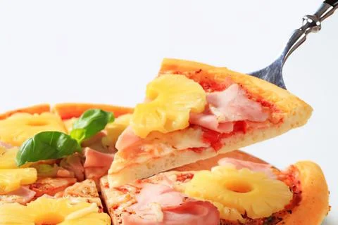 Delicious slice of ham and pineapple pizza Stock Photos