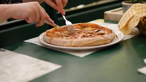 A delicious slice of pizza served on a beautiful plate in a cozy restaurant Video stock 283629224