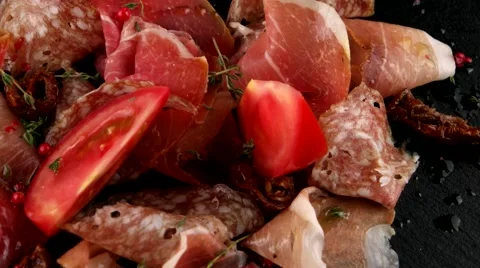 Delicious sliced ham, salami, bacon and tomatoes, closeup, loop Stock Footage 66481716