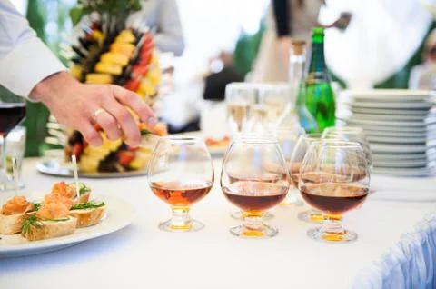 Delicious snacks on wedding reception table in luxury outdoor restaurant Stock Photos