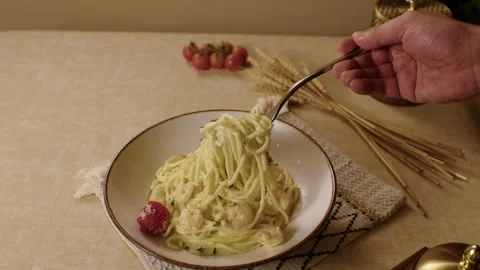 Delicious spaghetti with shrimp twirling on a fork in a white bowl Stock Footage 345146107