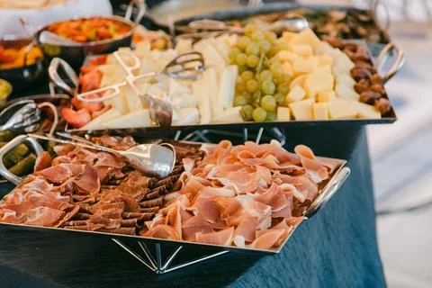 Delicious spread of assorted cheeses, meats, and fruits showcased at a festive Stock Photos