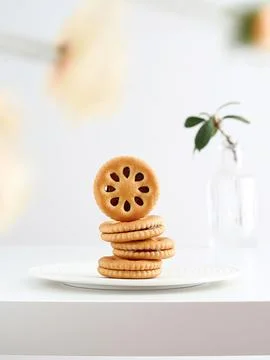 Delicious stack of cookies placed on a white plate atop a table Stock Photos