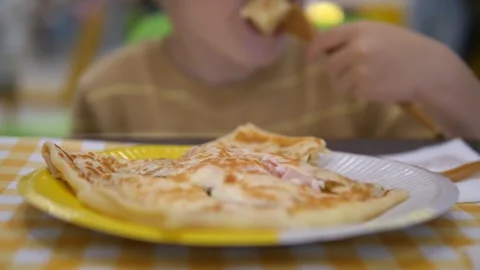 A delicious stack of fresh, golden pancakes fills the foreground while a young 스톡 동영상 319001204
