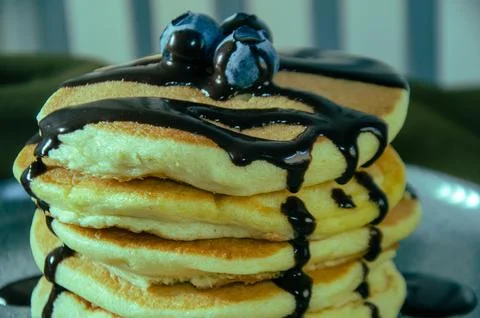 Delicious Stack of Pancakes with Chocolate Syrup and Blueberries Stock Photos