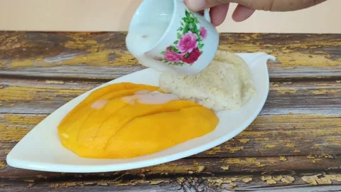Delicious sticky rice with mango drench in sweeten coconut milk Stock Footage 150288941