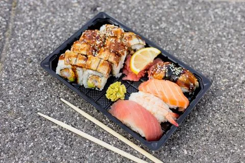 A delicious sushi platter features assorted rolls, sashimi, and wasabi, all.. Stock Photos