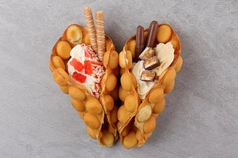 Delicious sweet bubble waffle on table Stock Photos
