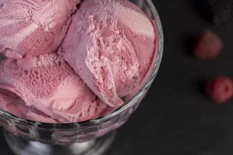Delicious sweet cold raspberry flavored ice cream and ripe raspberries in a.. Stock Photos