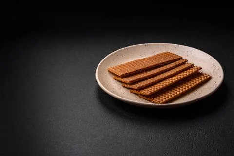 Delicious sweet crispy rectangular waffles on a ceramic plate Stockfoto's