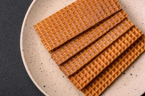 Delicious sweet crispy rectangular waffles on a ceramic plate Stockfoto's
