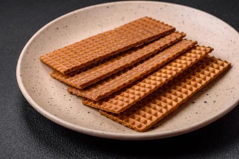 Delicious sweet crispy rectangular waffles on a ceramic plate Stock Photos