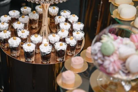 Delicious sweets on candy buffet. Table with sweets, buffet with cupcakes, Ma Stock Photos