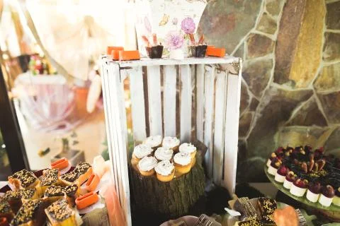 Delicious sweets on wedding candy buffet with desserts, cupcakes Stock Photos