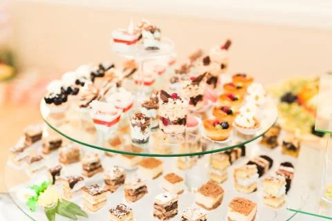 Delicious sweets on wedding candy buffet with desserts, cupcakes Stock Photos