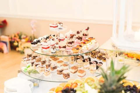 Delicious sweets on wedding candy buffet with desserts, cupcakes Stock Photos