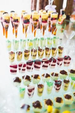 Delicious sweets on wedding candy buffet with desserts, cupcakes Stock Photos