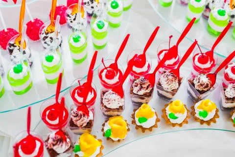 Delicious sweets on wedding candy buffet with desserts, cupcakes Stock Photos