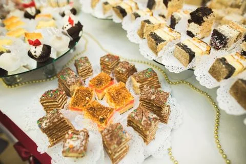 Delicious sweets on wedding candy buffet with desserts, cupcakes Stock Photos