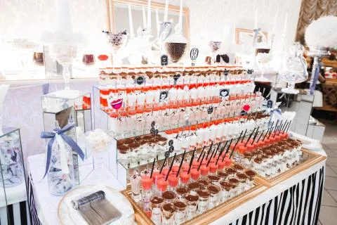Delicious sweets on wedding candy buffet with desserts, cupcakes Stock Photos