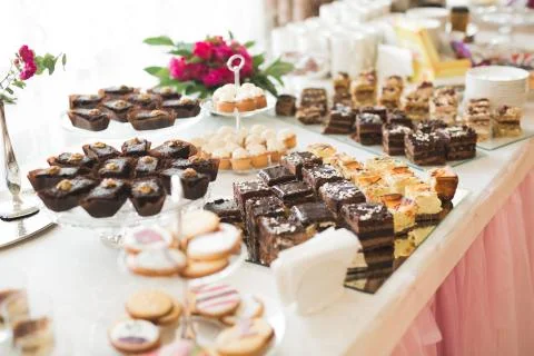 Delicious sweets on wedding candy buffet with desserts, cupcakes Stock Photos