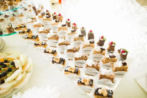 Delicious sweets on wedding candy buffet with desserts, cupcakes Stock Photos