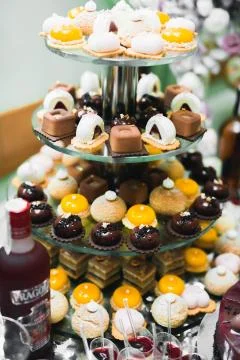 Delicious sweets on wedding candy buffet with desserts, cupcakes Stock Photos