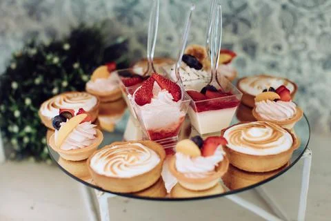 Delicious sweets on wedding candy buffet with desserts. Catering service Stock Photos