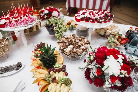 Delicious sweets on wedding candy buffet with desserts, cupcakes Stock Photos