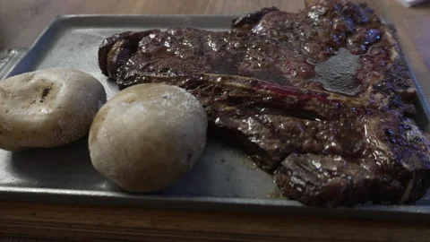 Delicious t-bone steak with potatoes meal Stock Footage 345552053