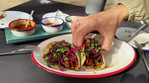 Delicious tacos with pulled pork and beans, pickled onions and fresh herbs Stock Footage 315446322