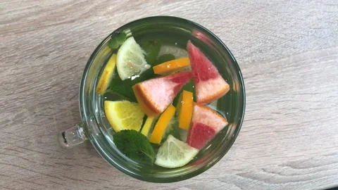 Delicious tea with lemon, mint, orange and grapefruit. View from above. 動画素材 145102068