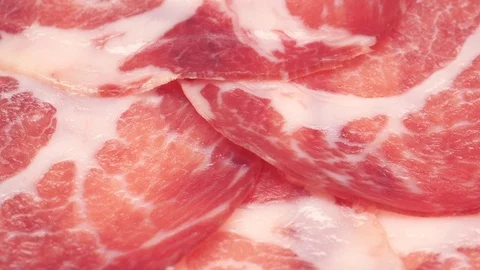 Delicious thin sliced Coppa or Capicola ham on a turntable in UHD 動画素材 95481013